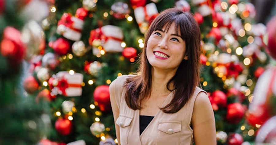 woman in front of a christmas tree