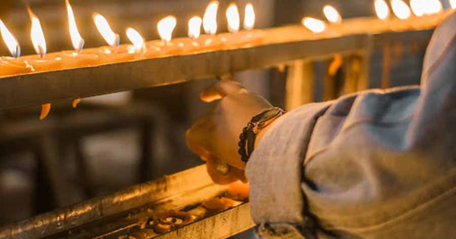 person lighting candles